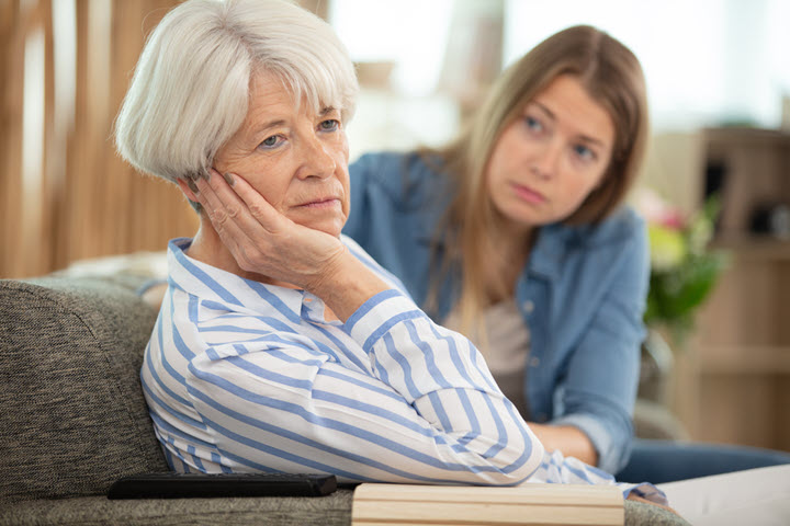 young woman taking care of older woman with alzheimers